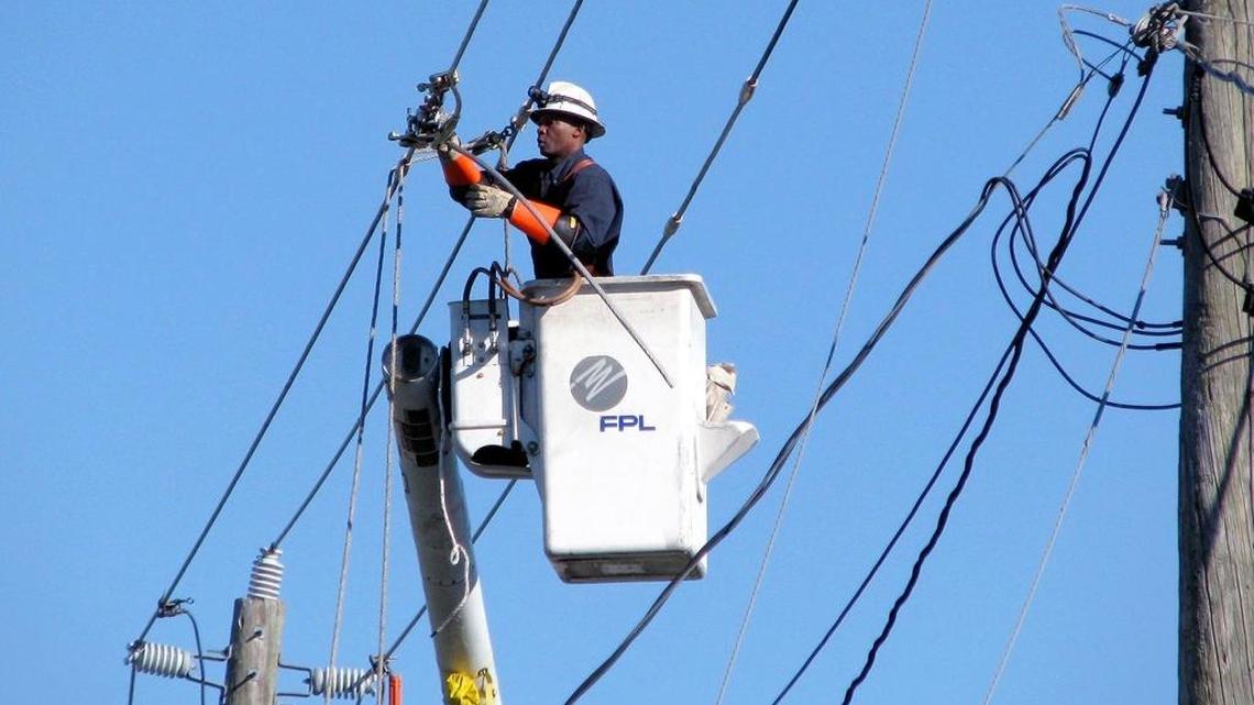 An FPL worker repairs a line in Hialeah.