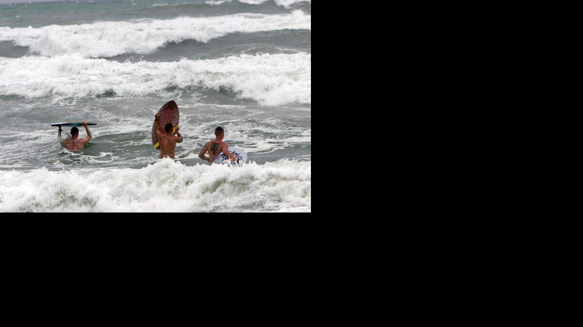 
Surfers in North Carolina grabbed their boards the day before Hurricane Arthur made landfall July 4, the only storm of the 2014 season to strike the U.S. coast.
