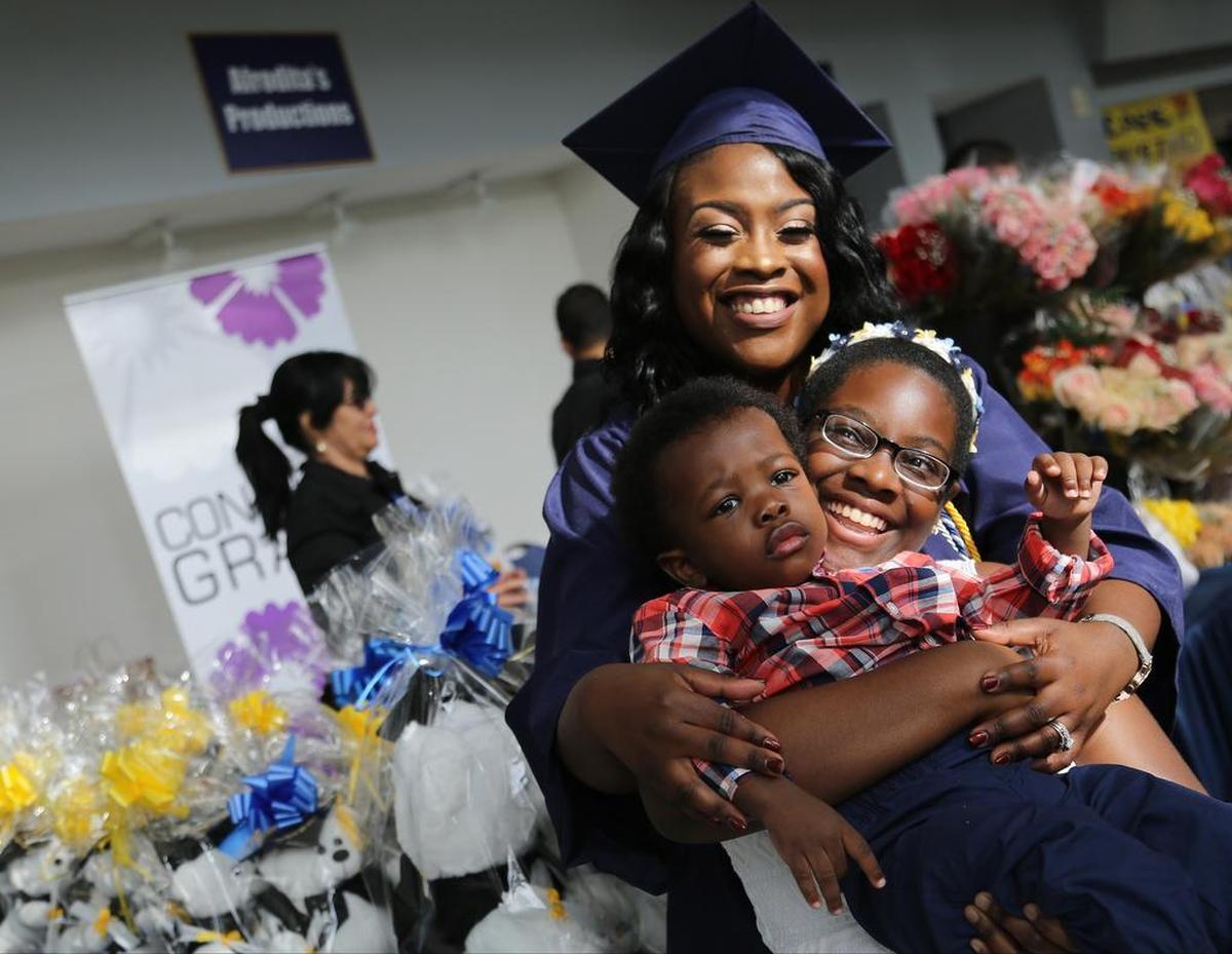 On Wednesday, May 3, 2017 Nyamekye Daniel, 31, center, earns her Bachelor of Science and celebrates with her children Nyla Daniels, 11, right, and Braylon Betts, 1, left, after overcoming many tragic moments in her life.