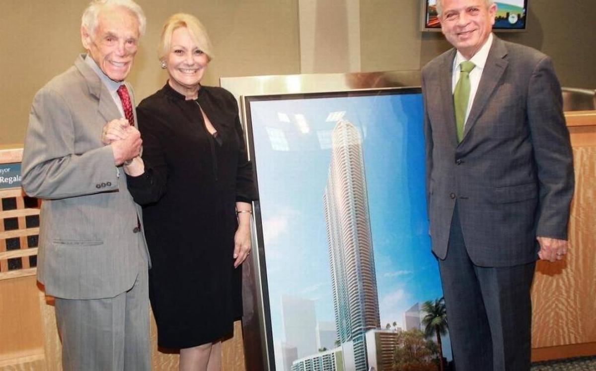 From left: Tibor Hollo, Mikki Canton and former Miami Mayor Tomas Regalado stand in Miami City Hall with a rendering of Panorama Tower, a high-rise that’s received financing through the city’s EB-5 regional center.