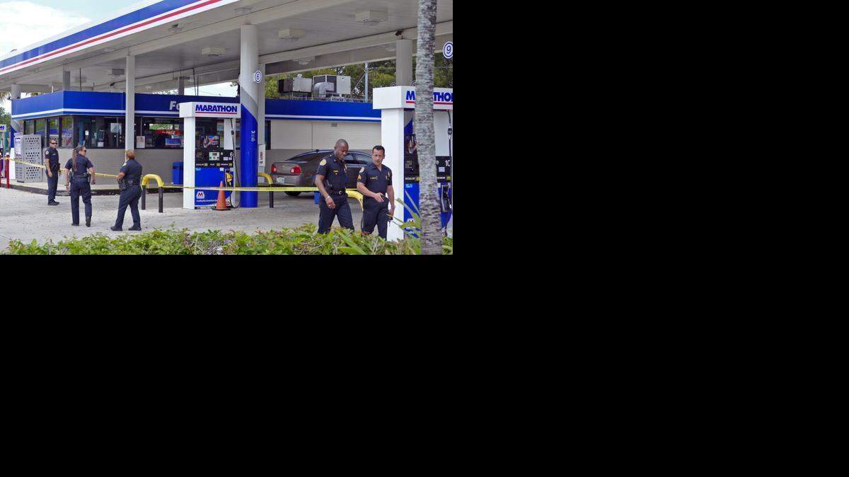 
Miami police work a shooting scene at the Marathon Gas Station at Southwest 37th Avenue and 16th Street on Monday, March 30, 2015. 
