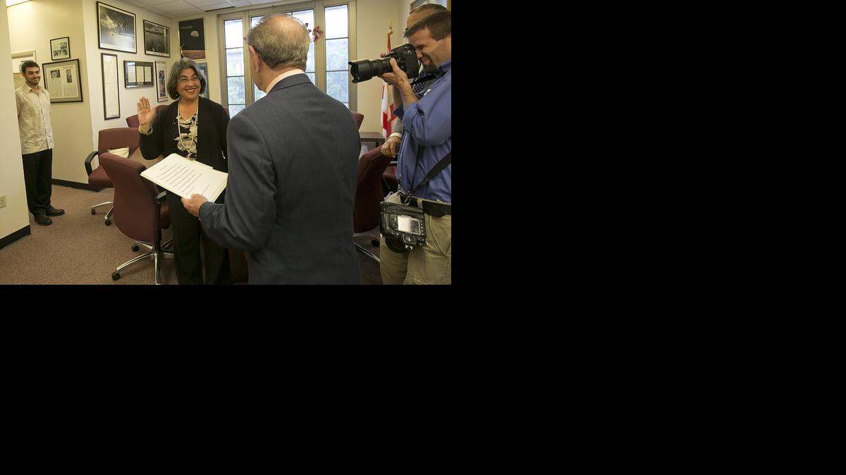 
Miami-Dade's newest commissioner, Daniella Levine Cava, takes her oath of office with Court Clerk Harvey Ruvin on Tuesday, Nov. 18, 2014 as her son Ted Cava, left, looks on.
