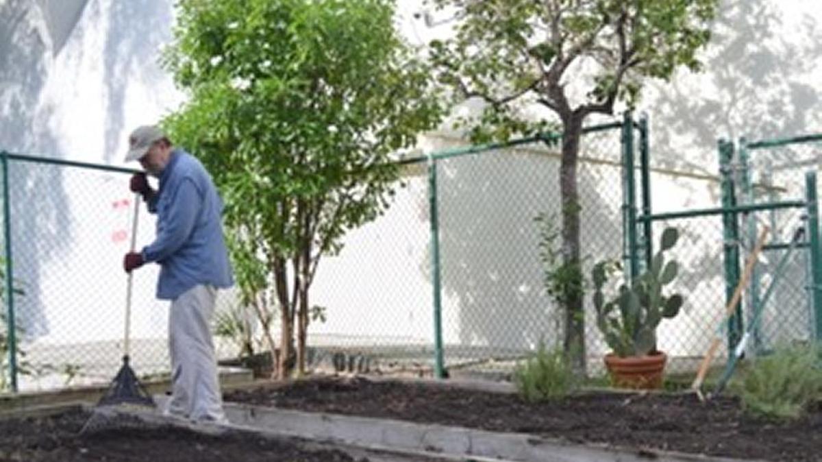 
David Galler rakes the earth in the Temple Israel’s edible garden Sunday morning. Sunday was the first day of this garden’s sixth growing season, and all proceeds are donated to Lotus House, a shelter for homeless women and children. 
