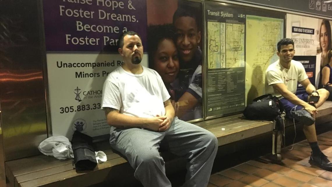 Luis Gonzalez, left, and Erick Araujo await a southbound Metrorail train at the Brickell station as midnight approaches. Both are concerned about earlier closing times arriving Monday, May 22, 2017.