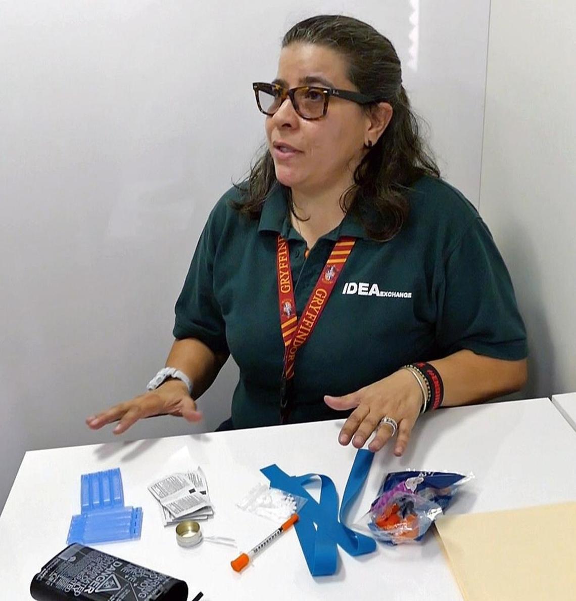 Emelina Martinez, an employee at the Idea Exchange needle exchange program, showing reporters clean paraphernelia given to addicts in Overtown.