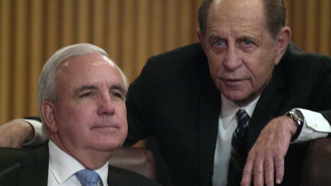 Miami-Dade Mayor Carlos Gimenez, left, and Harvey Ruvin, clerk of the courts, talk during a February meeting of the Miami-Dade County Commission. The two on Wednesday announced the discovery of $2 million to patch a budget hole in Ruvin’s office and avoid the closure of seven satellite clerk facilities.