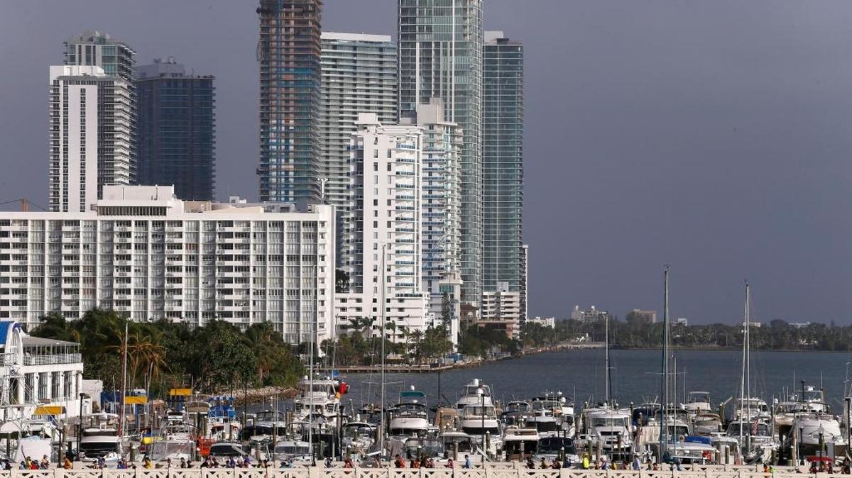 Runners make their way across the Venetian Causeway during the Miami Marathon and Half Marathon on a very windy Sunday.