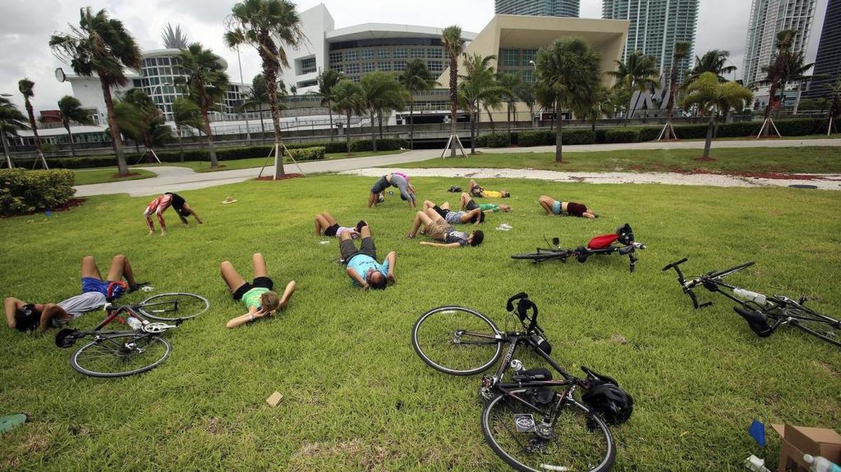 
A Yoga class led by Sumer Thomas of Miami, far left at back, was one of the activities open to people attending a dedication of a parcel of land behind AmericanAirlines Arena as Dan Paul Park, on Saturday, June 13, 2015. Presented by Emerge Miami, the Urban Environment League and the New Tropic, the event was open to the public. Activists say that Miami-Dade County and the Miami Heat have not fulfilled a promise to turn the three-acre waterfront lot into a public park. The dedication of the land as Dan Paul Park honors Paul, a Miami attorney, civic activist and longtime parks advocate who died in 2010.
