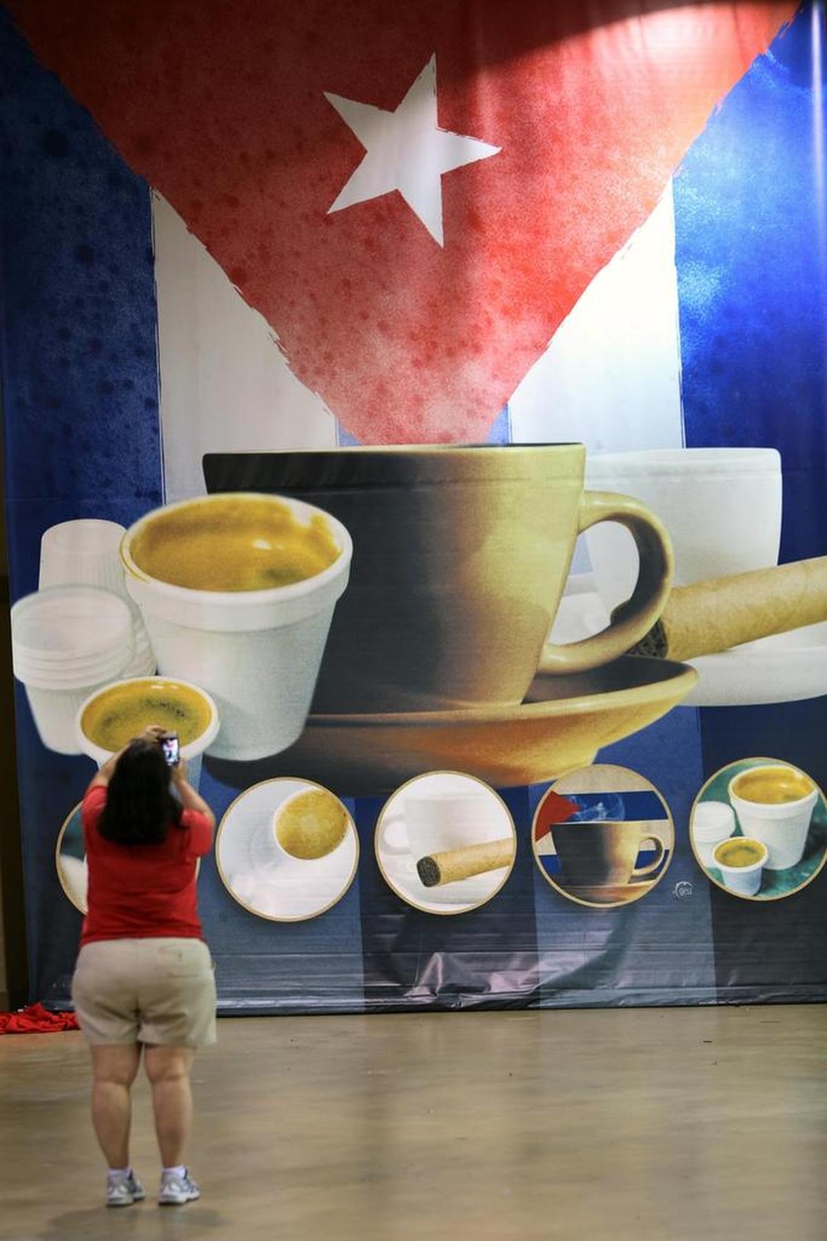 A photo is taken of a banner hanging inside the CubaNostalgia exhibit.