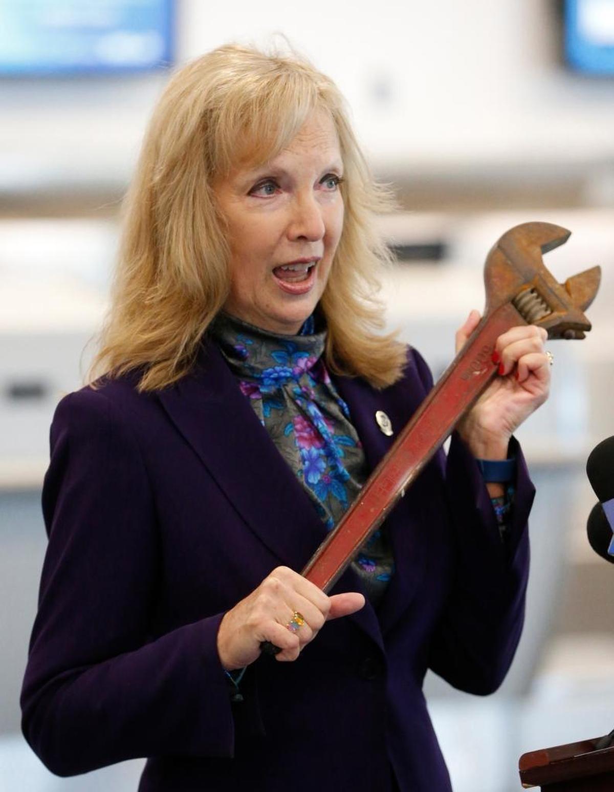 TSA Public Affairs Manager Sari Koshetz holds up a large wrench that was found in a passenger's carry-on luggage recently at Miami International Airport.