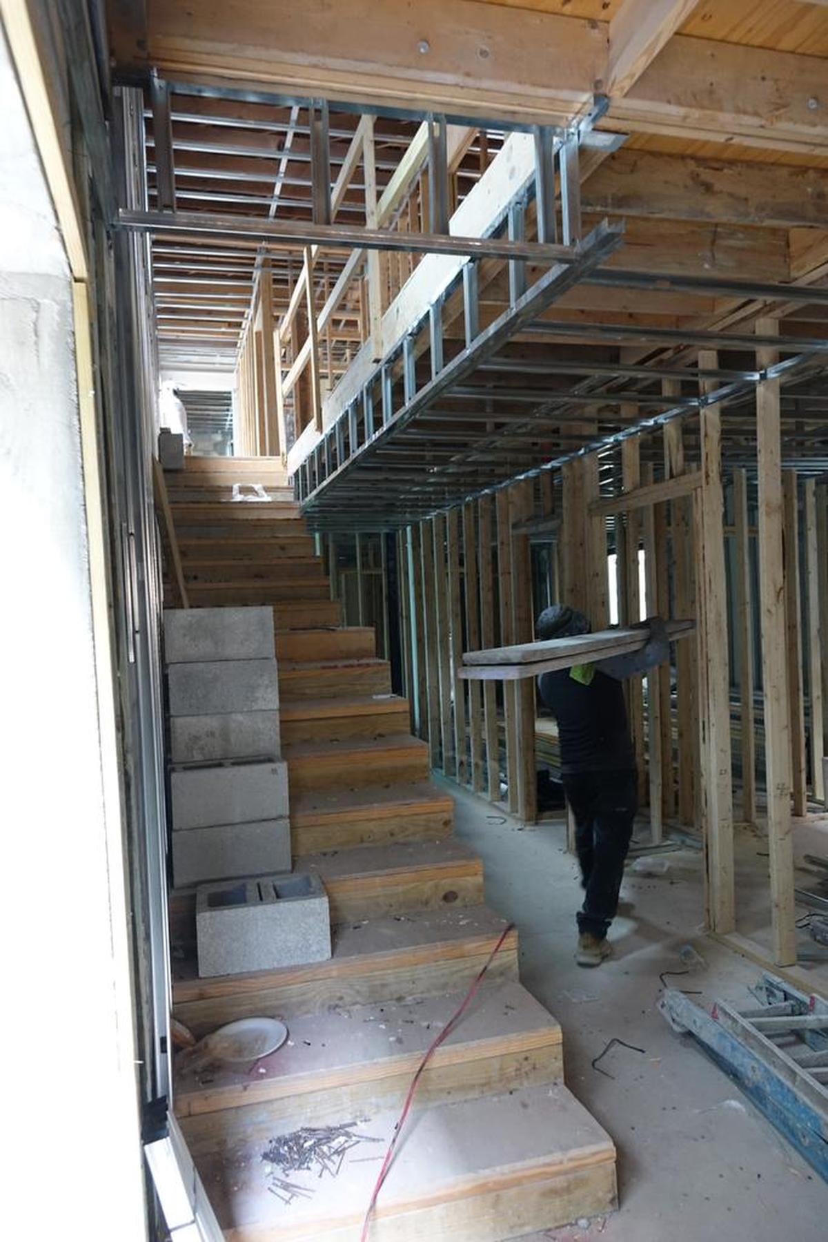 Workers at the Josephine and Dunn Hotel in Overtown. Nearly three years after crews broke ground on the taxpayer-funded project, renovation of the building is nowhere near done.