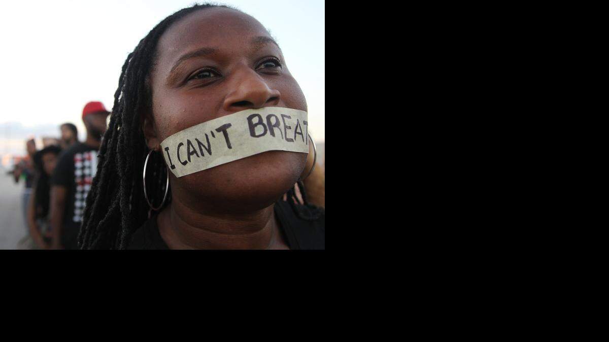 
A protester tapes her mouth with the words "I can't breathe." Marchers shut down major Midtown, Wynwood streets and the 112 both east and westbound in protest of police violence against civilians that caused several deaths of unarmed boys and men in S. Florida on Sunday, Dec. 7, 2014 on the last day of Art Basel weekend.

