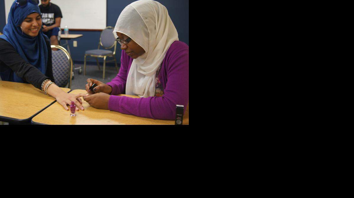 
Nandee Shabazz, right, paints Sara Haroon’s nails.
