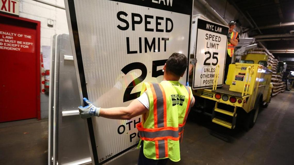A worker at the Transportation Department sign shop in Maspeth, Queens, with a new sign.