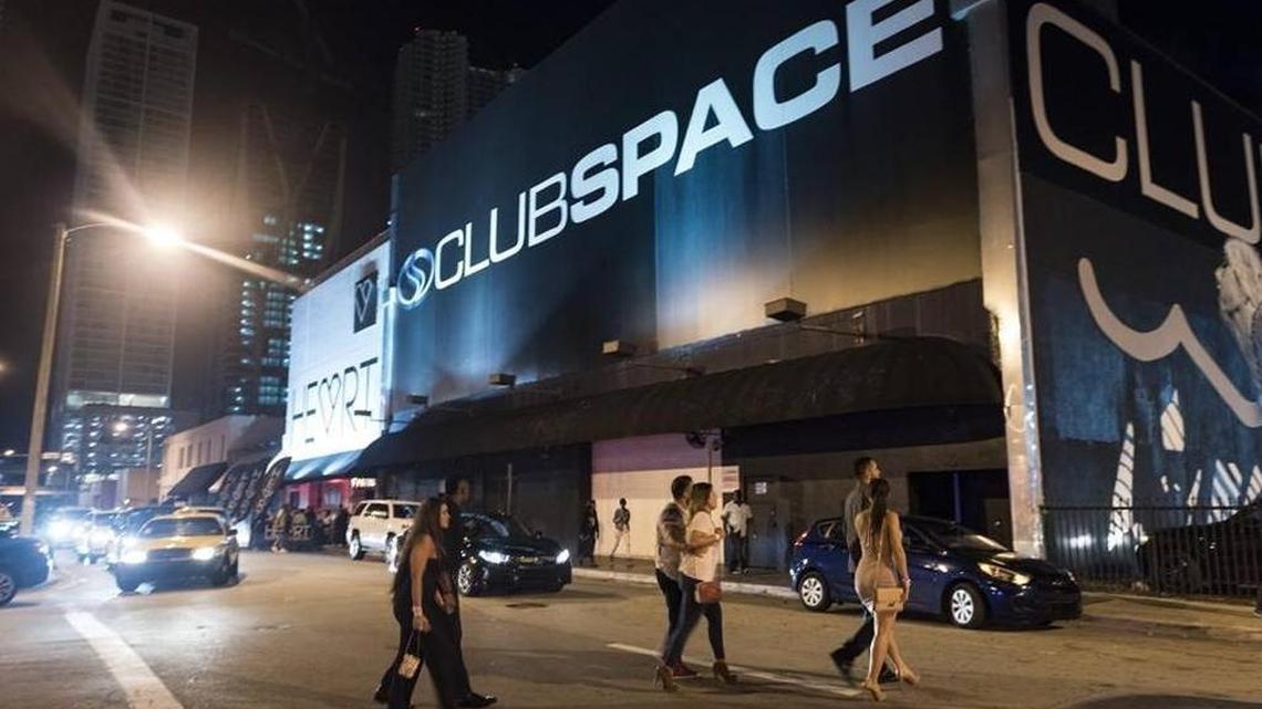 Club goers walk towards the parking lots at 5 a.m. last Saturday morning at a string of downtown music clubs that have drawn noise complaints from residents of condo towers blocks away. The clubs are fighting noise violations recently issued by the city.