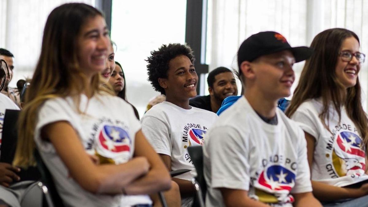 Student Lazaro Valdez, center, listens during the graduation ceremony of Miami-Dade Police Department’s first Teen Citizen's Police Academy at the department’s headquarters in Doral on Friday, Aug. 18, 2017.