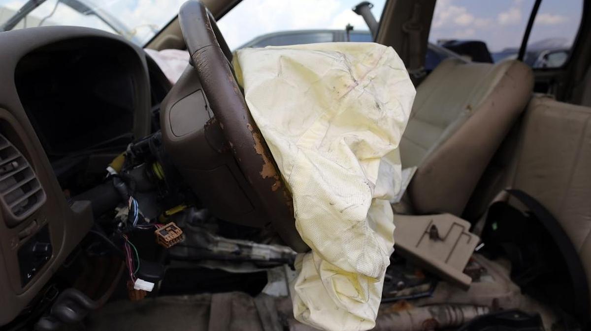 A deployed airbag is seen in a Nissan vehicle at the LKQ Pick Your Part salvage yard in Medley.