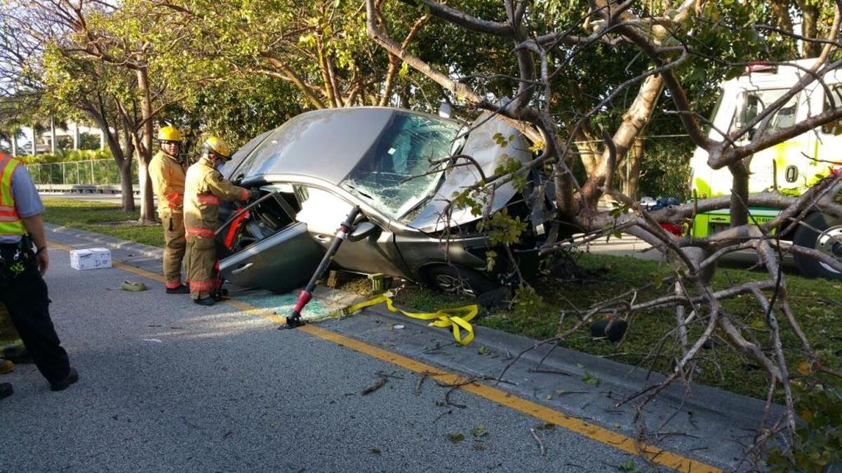 Miami-Dade Fire Rescue saved a trapped man when he crashed his car into a tree near Northwest 52nd Street and Northwest 87th Street Friday morning.