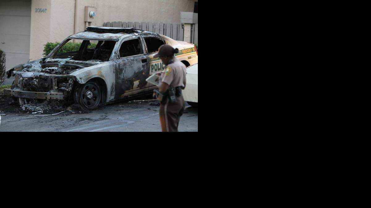 
Two marked police cruisers were torched in NE Miami-Dade County Friday, March 13, 2015. One cruiser is a Hallandale police unit and the other is a Miami-Dade police unit.
