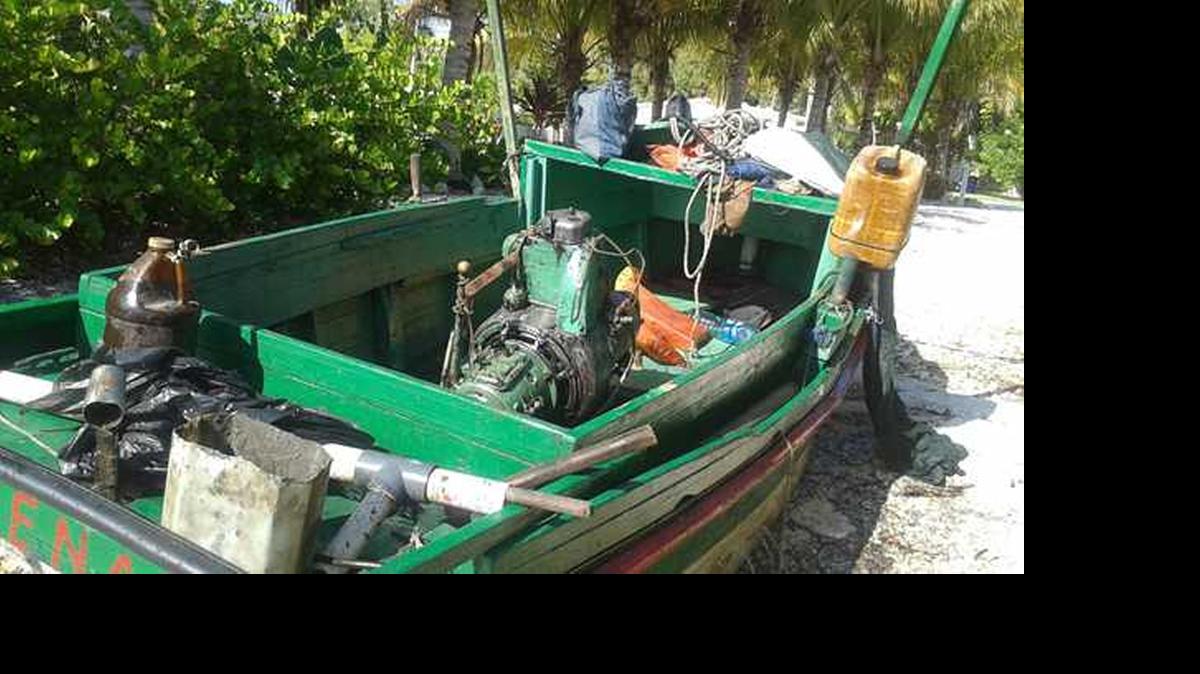 
The migrants' vessel sits on land after removal from city waters. 
