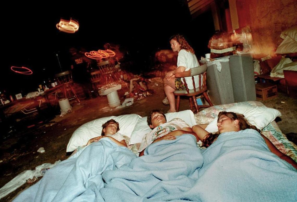 Ellen Hatem kept watch over her children, Katrina, 10, Andrew, 12 and Angela, 14, in the parking lot of the Days Inn the family owned in Homestead after Hurricane Andrew struck.