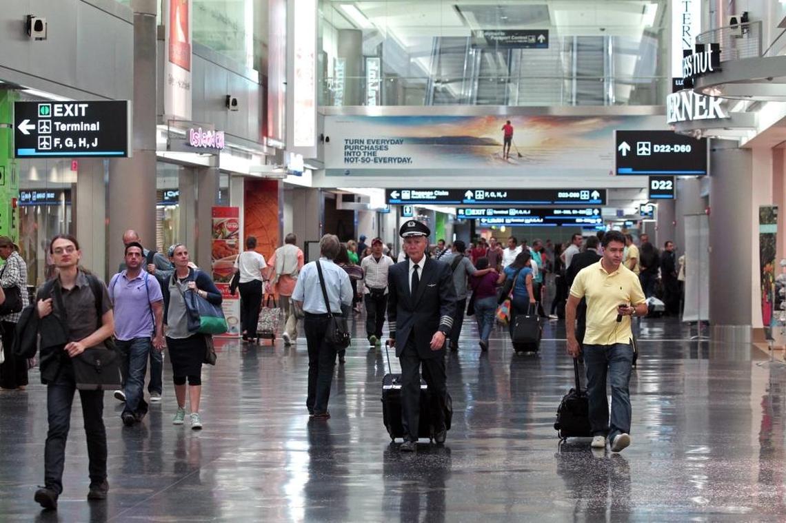 Passengers make their way to the gates at Miami International Airport, a bustle patrons of a planned VIP terminal could avoid.
