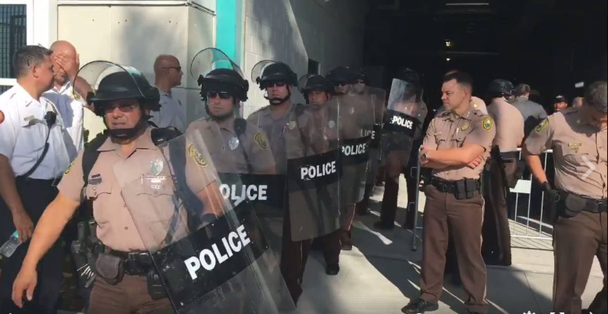 Police in riot gear enter Hard Rock Stadium before the El Clasico game at Hard Rock Stadium on July 30.