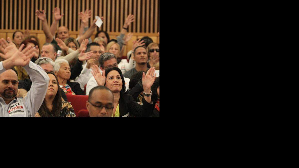 
Opponents of a proposal to ban discrimination against transgender people waved their hands in disagreement during Wednesday’s Miami-Dade County committee meeting.
