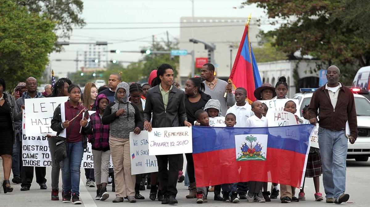 Children and adults lead a group of marchers through the streets of Little Haiti heading southbound on NE 2nd Avenue to attend the prayer vigil at the Little Haiti Cultural Complex in Miami, Florida on Tuesday, Jan. 12, 2016. The Miami Haitian community held a moment of silence at the Toussaint L'Ouverture statue then walked to the Little Haiti Cultural Complex for a prayer vigil in remembrance of those who died and were injured by the Haiti Earthquake of 2010.