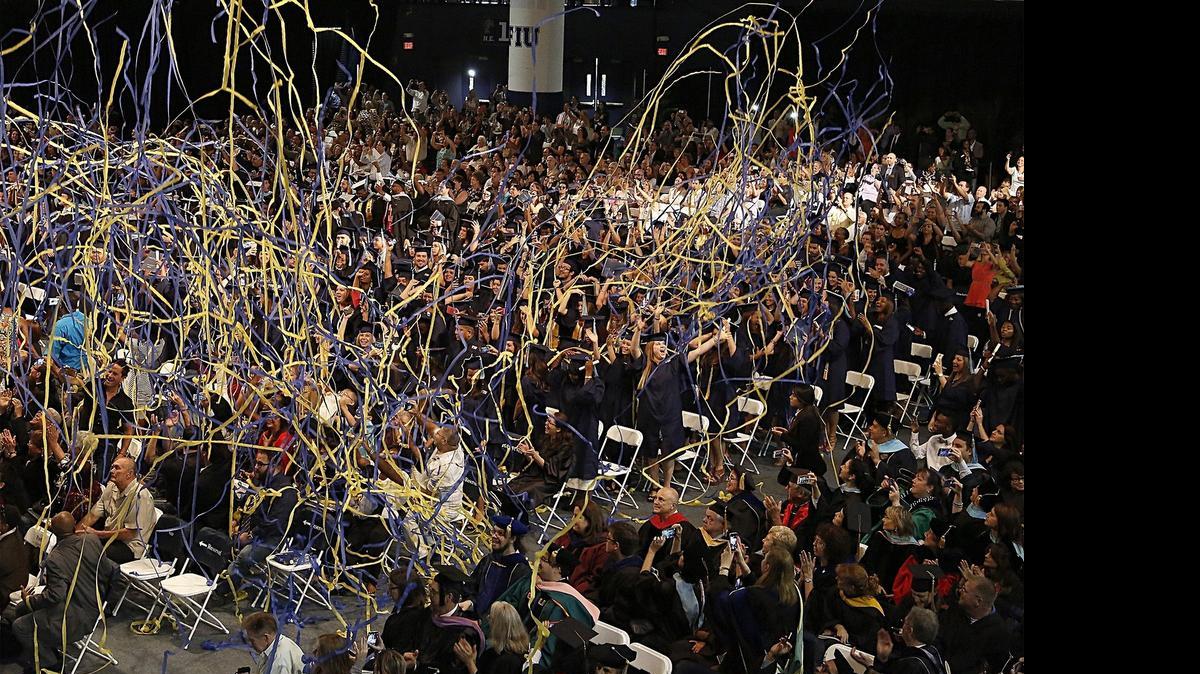
Festive confetti string rains on the FIU Class of 2015 as Florida International University held its commencement ceremonies for the colleges of Architecture and Arts, Education, Graduate School, Undergraduate Education, and Honors inside the FIU arena at Modesto A. Maidique Campus in West Miami-Dade on Sunday, May 3, 2015.
