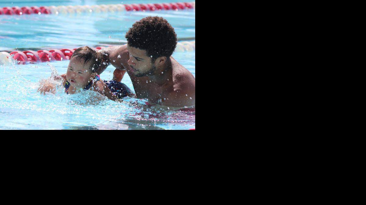 
Luis Manuel Perez, 22, teaches Kailee Flores, 1, how to swim at Rockway Middle School’s pool. Perez is a coach at the Down Syndrome Association of Miami and teaches children swimming lessons every Saturday of the week, from 10:30 a.m. to 12:30 p.m.
