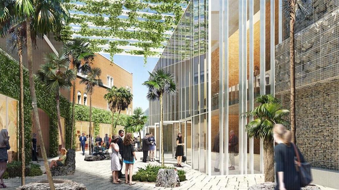 A rendering of the proposed redevelopment of the Coconut Grove Playhouse shows the historic Mediterranean building to the left separated from a modern new theater, covered in rough rock and glass at left, with a public plaza in the middle.