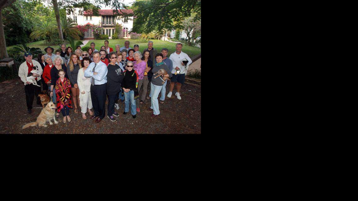 
Rick Zelman (front center with the tie) and Jennifer Beber (front and center next to Zelman in black) are among a group of outraged neighbors who have stepped in to trying to save a 1920s house in Coconut Grove.
