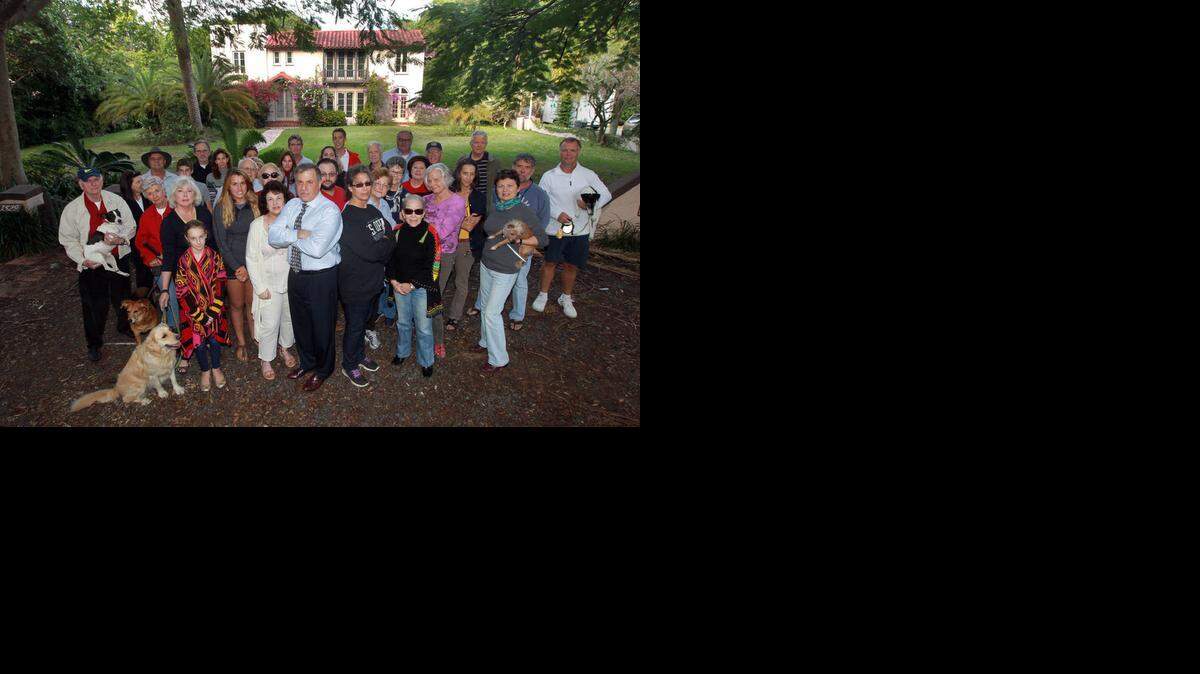 
Rick Zelman (front center with the tie) and Jennifer Beber (front and center next to Zelman in black) are among a group of outraged neighbors who have stepped in to trying to save a 1920s house in Coconut Grove.
