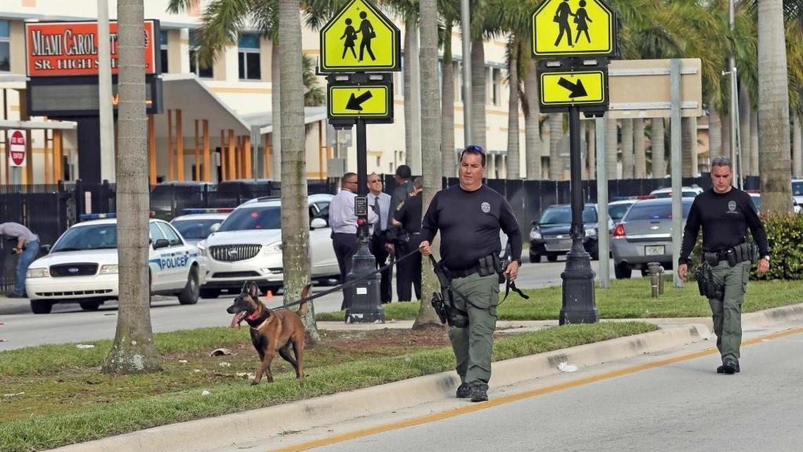 Miami Gardens Police K-9 officers look for bullet casings on Miami Gardens Drive across the street of Miami Carol City Senior High School where a shooting occurred Wednesday afternoon. No one was hurt.
