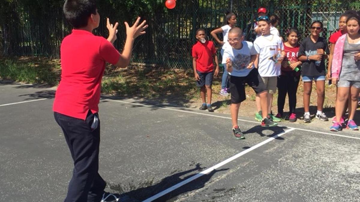 
Field Day Fun: Brian Patino tosses a balloon to classmates at a field day event at Frances Tucker Elementary, which has a new fitness center.
