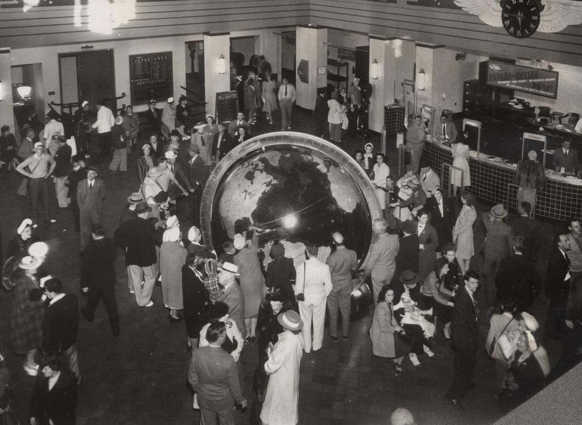 Visitors crowd around the globe of the world at the Pan Am seaplane terminal in Coconut Grove, now Miami’s City Hall, in the mid-1930s.