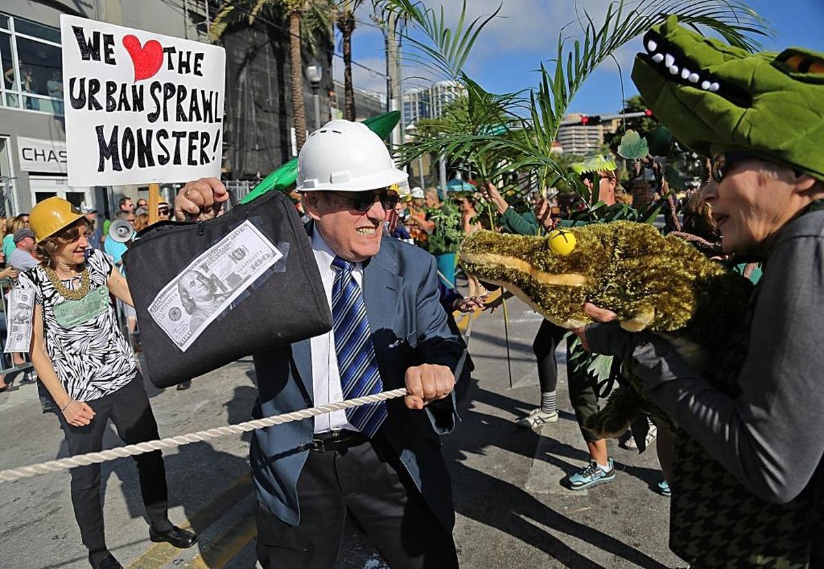 The battle between developers and the environment rages as alligators and plant life fight to hold ground during the 36th Annual King Mango Strut parade in Coconut Grove in 2017.