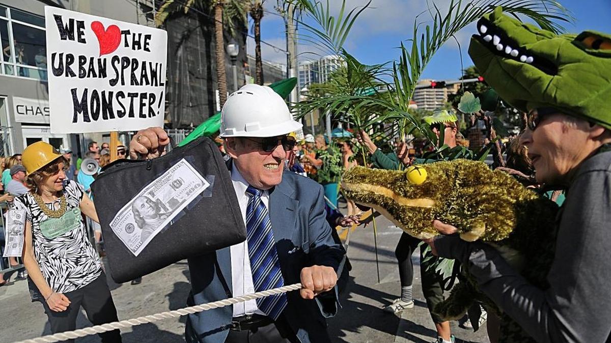 The battle between developers and the environment rages as alligators and plant life fight to hold ground during the 36th Annual King Mango Strut parade in Coconut Grove in 2017.