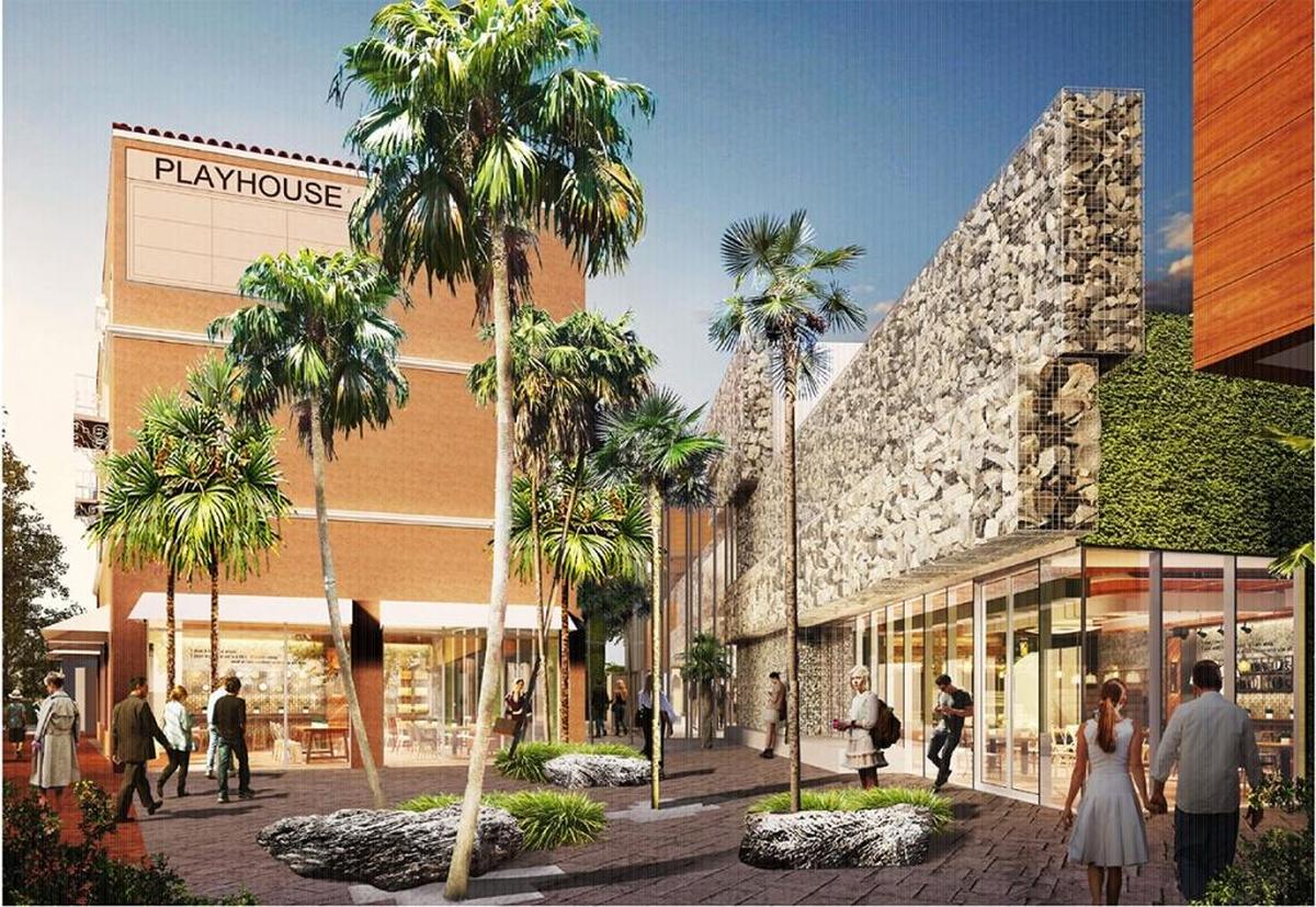A rendering of the proposed redevelopment of the Coconut Grove Playhouse shows the historic Mediterranean building on Main Highway to the left. It’s separated from a modern new theater, covered in rough rock and glass at left, with a public plaza at the center.