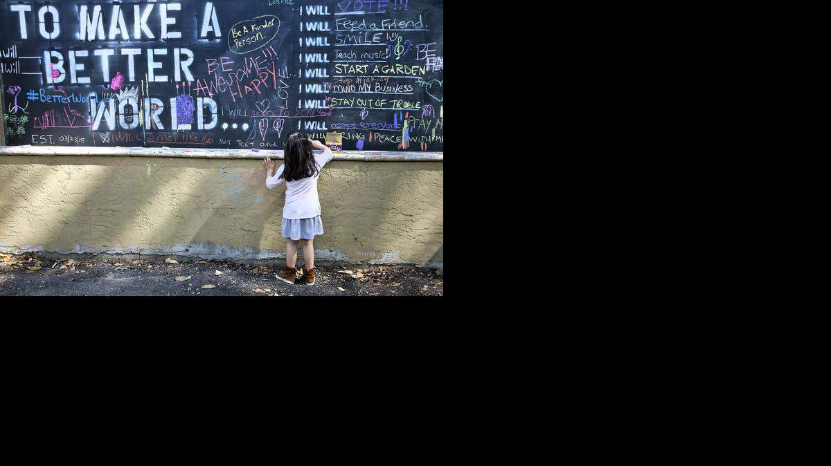 
Talia Fellig 6, leaves her message on the “To Make a Better World” wall at the Bet Ovadia- Chabad of the Grove at 3713 Main Hwy. in Coconut Grove on Tuesday, March 24, 2015.
