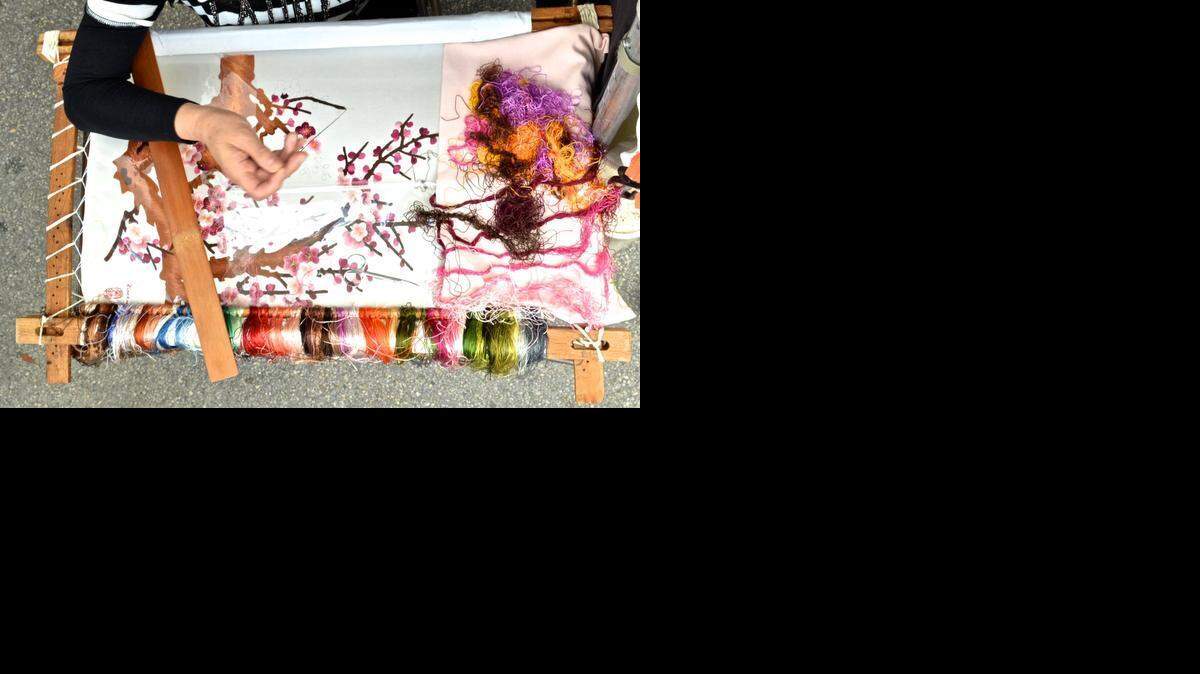 
Xiao Xia, first place winner for fiber, uses needle and fiber to craft a photo-realistic cherry blossom tree at the 50th Annual Coconut Grove Arts Festival on President's Day in Coconut Grove.


