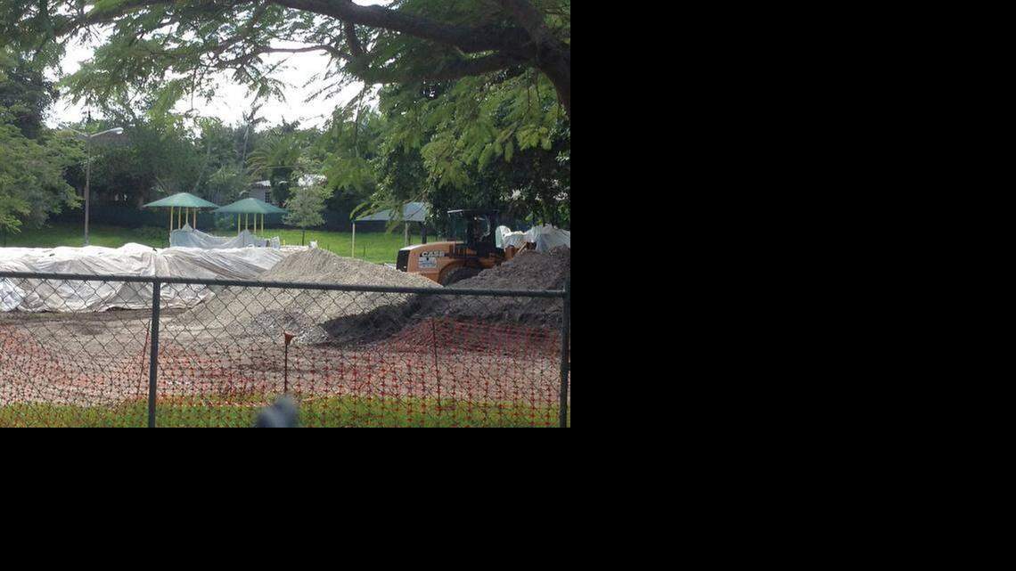 
Crews work at Merrie Christmas Park in Mid October. An anonymous donor has contributed $175,000 to pay for the city of Miami to remove the mound of tainted soil covered beneath white plastic.
