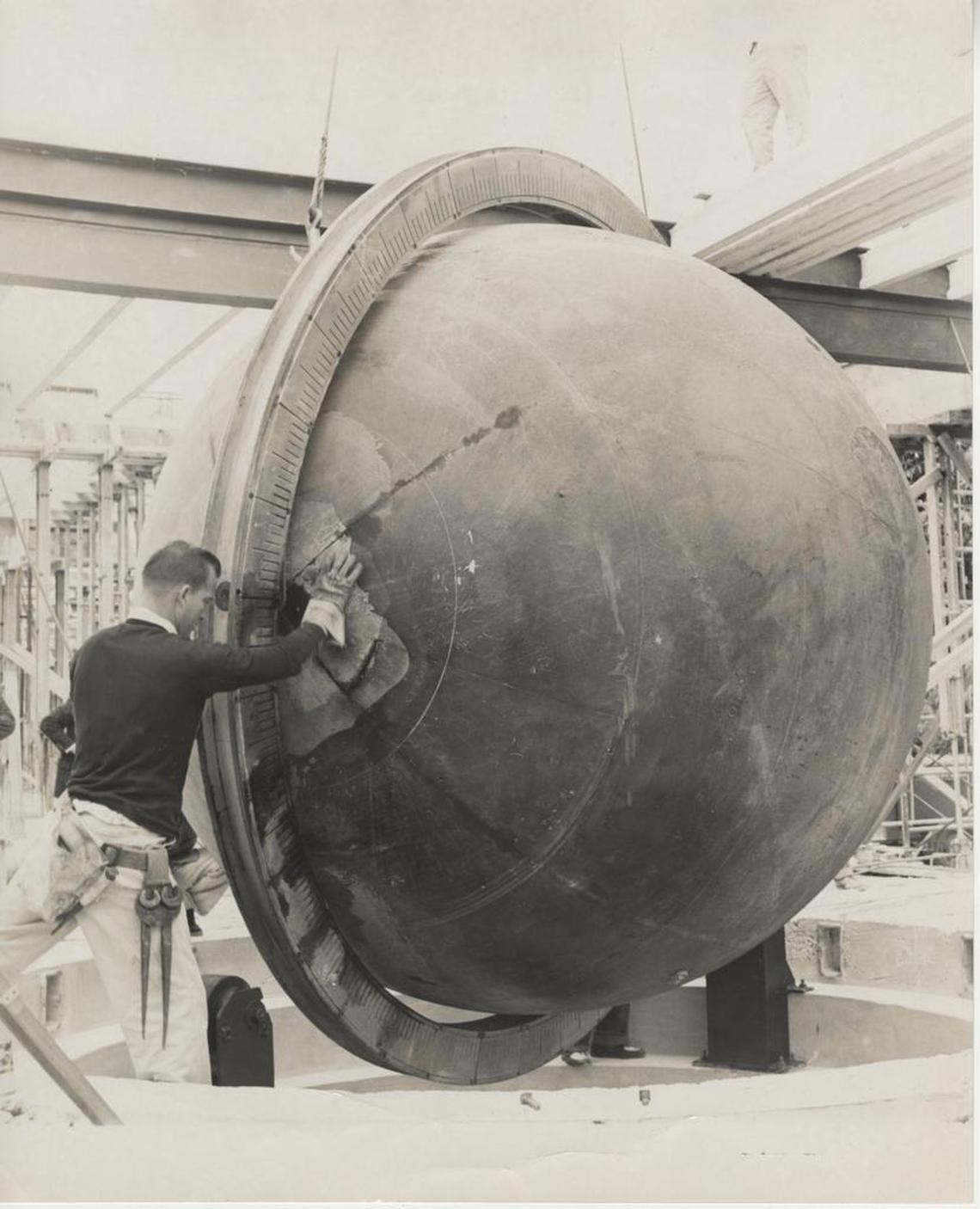 A worker jockeys the giant Pan Am world globe as it is being installed in 1960 at the then-new Miami Museum of Science.