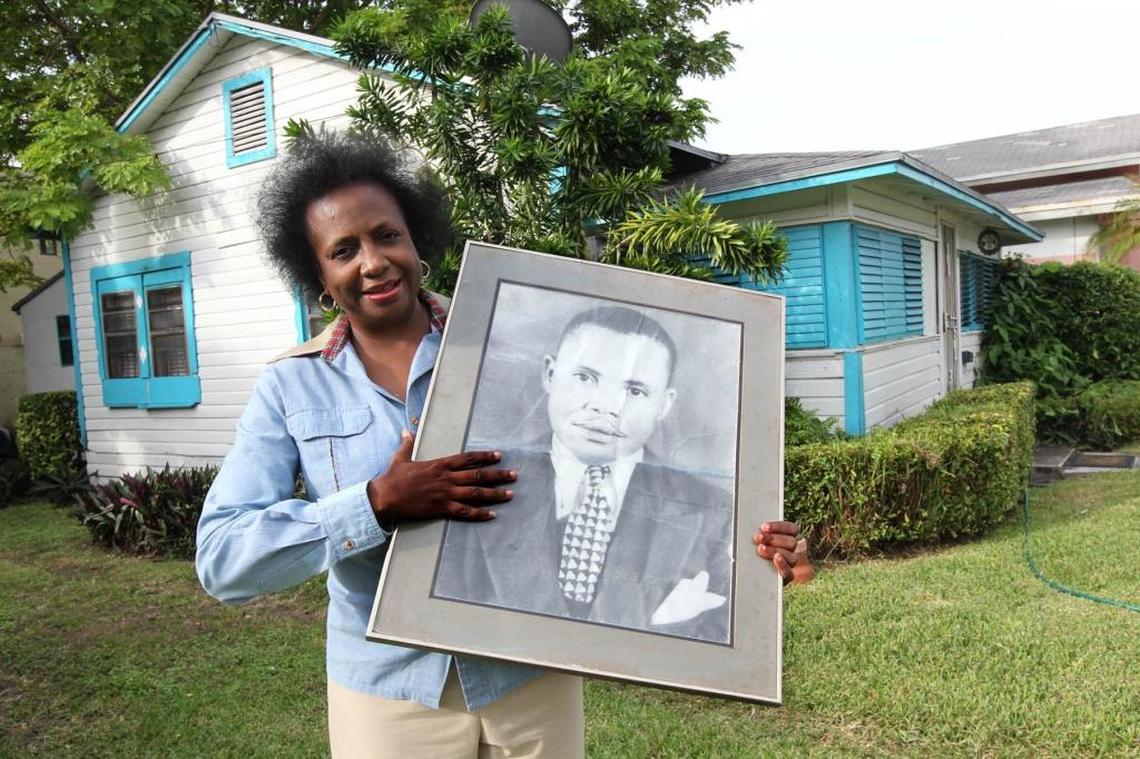 Shirley Gibson holds a picture of her father, Octavious Carlton Gibson, outside her wood-frame home in the MacFarlane Historic District in the portion of west Coconut Grove that falls inside Coral Gables boundaries. The photo was shot in 2011.