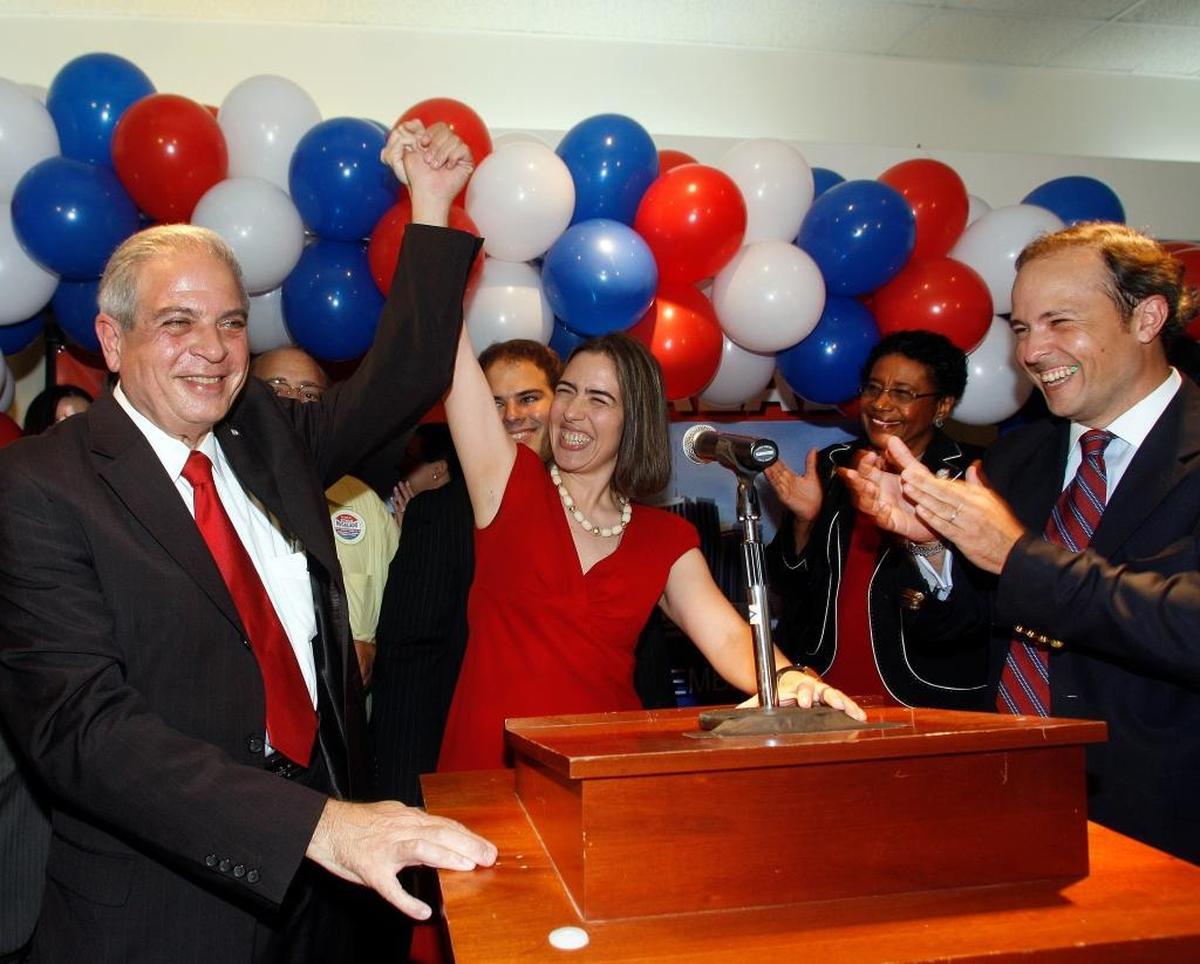 Tomas Regalado, left, holds daughter Raquel Regalado’s hand after winning Miami’s mayoral election in 2009. His youngest son, Jose, stands behind Raquel, and oldest son, Tommy, is on the right.