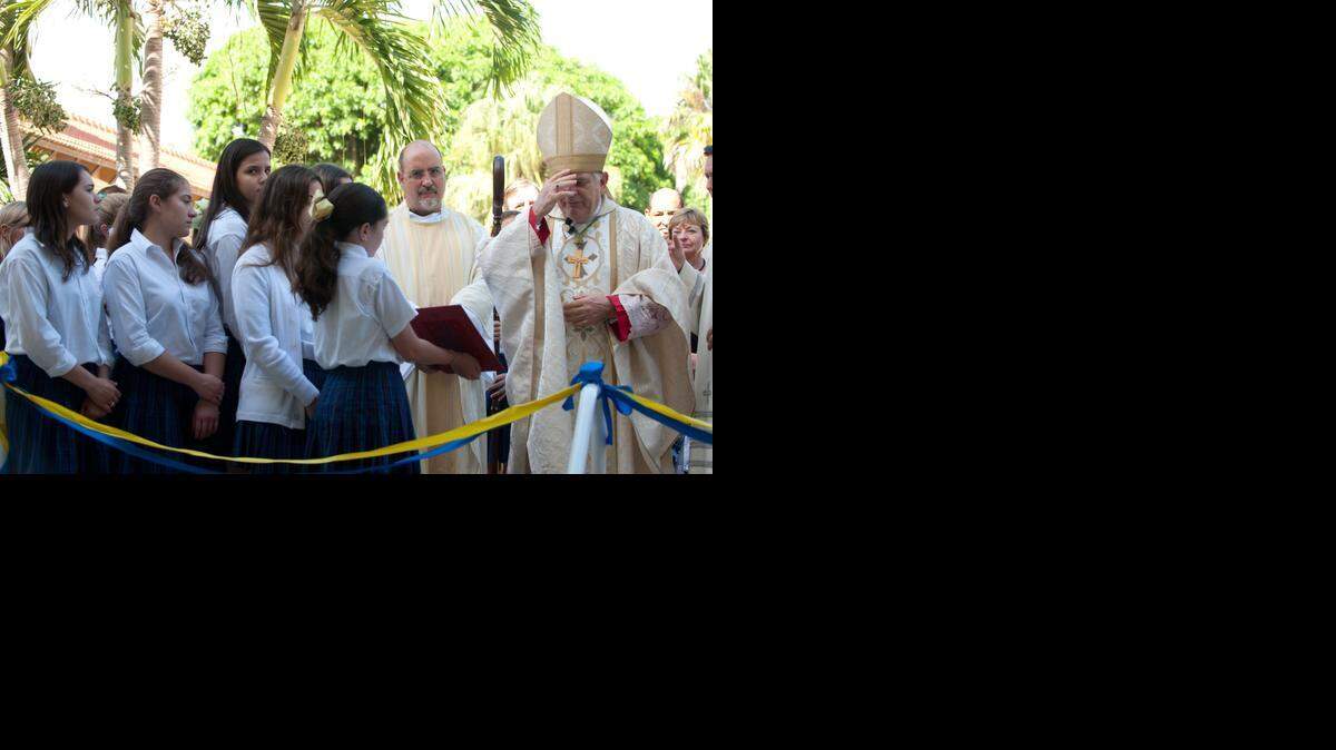 
Archbishop Thomas Wenski blesses the new wellness center at Carrollton School of the Sacred Heart in Coconut Grove, Monday, Nov. 24, 2014. Wenski led a special Mass as part of the dedication of the center.
