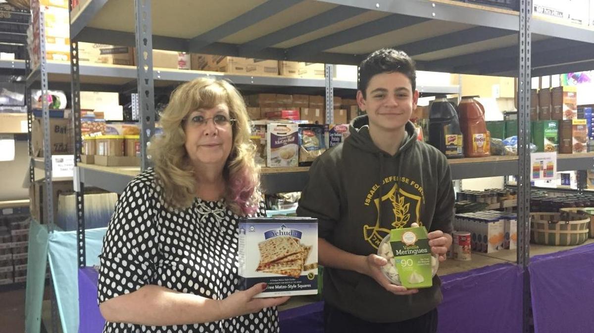 Bonnie Schwartzbaum, director of the Jewish Community Services Kosher Food Bank, and Aaron Kredi, a senior at American Heritage School, check out the gluten-free food section that Aaron created.