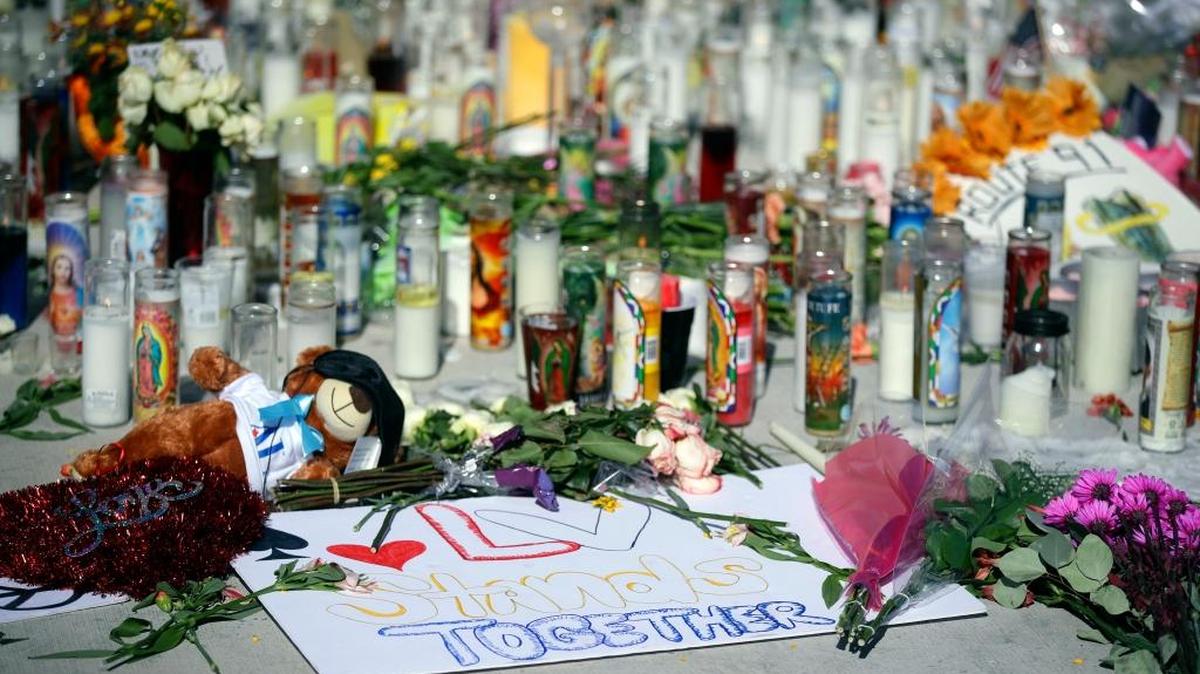 Flowers, candles and toys are left at a makeshift memorial site on Las Vegas Boulevard on Tuesday, Oct. 3, 2017, in Las Vegas. A gunman opened fire on an outdoor music concert on Sunday killing dozens and injuring hundreds.