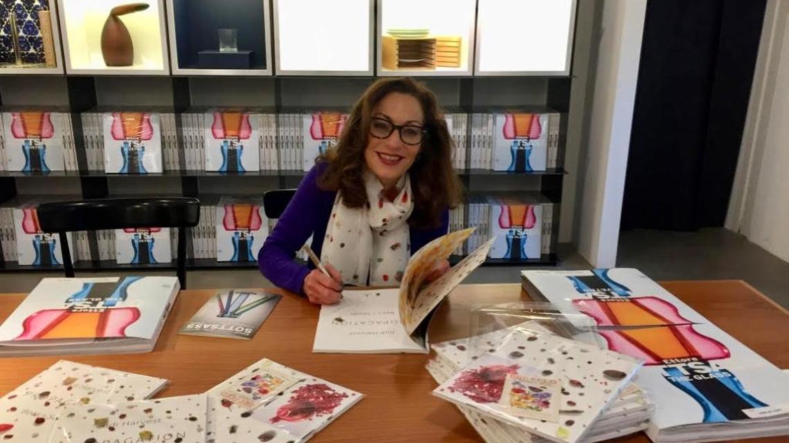 Judi Harvest signs her art exhibition catalogs at Le Stanze del Vetro's bookshop in Venice, May 2017.